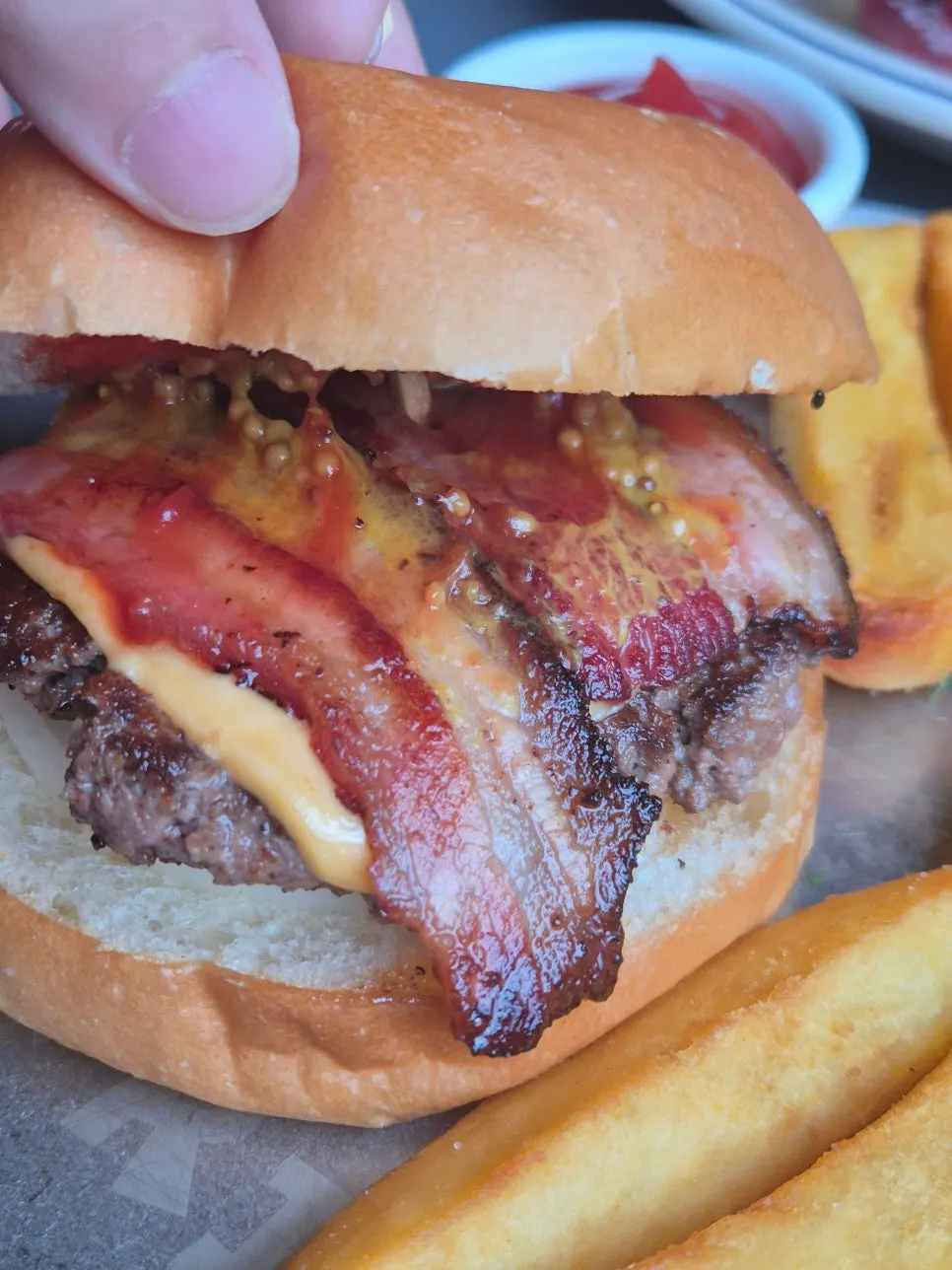 Homemade burger topped with bacon and cheese