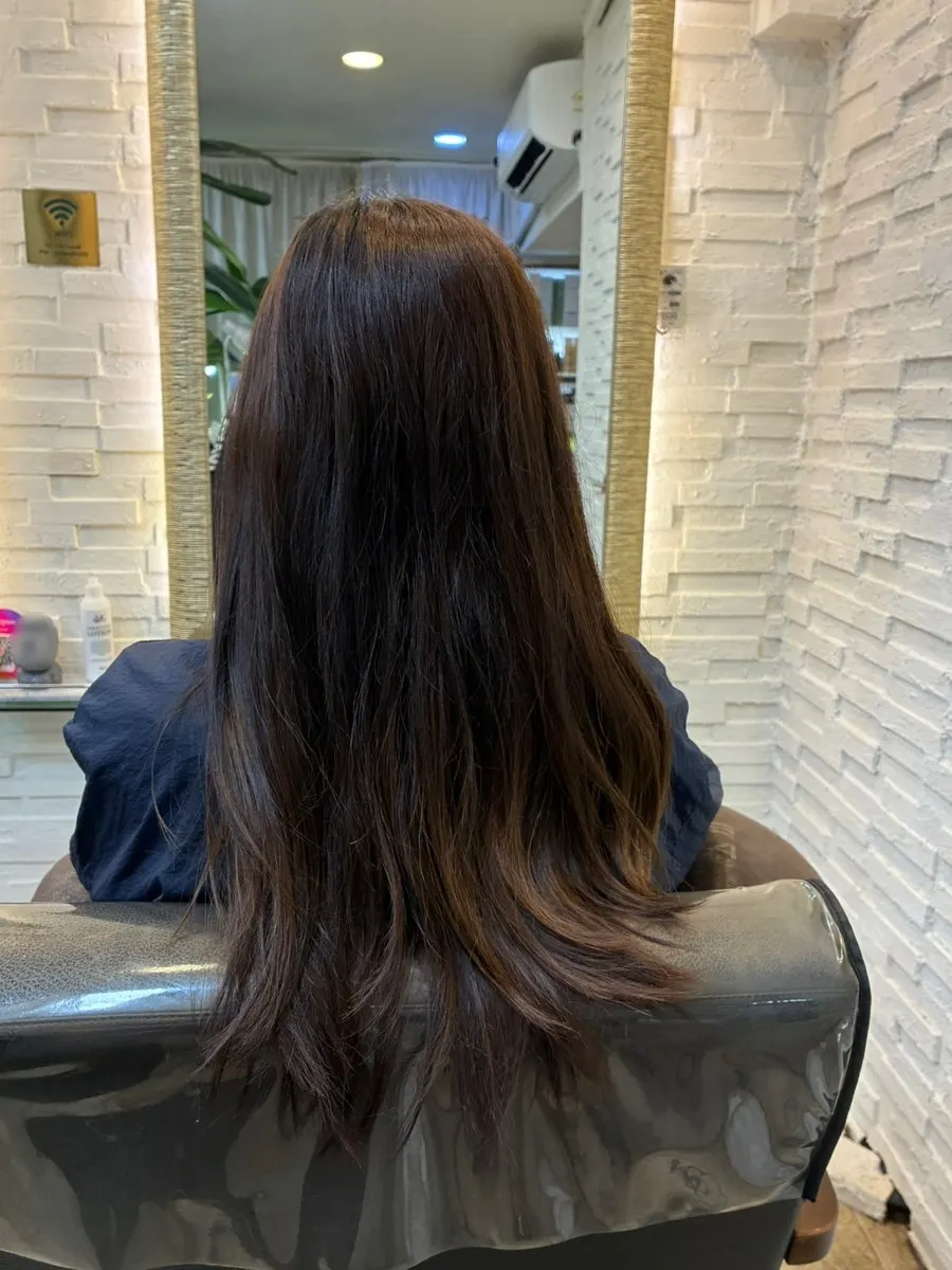 Mirror shot of bright brown hair before dyeing