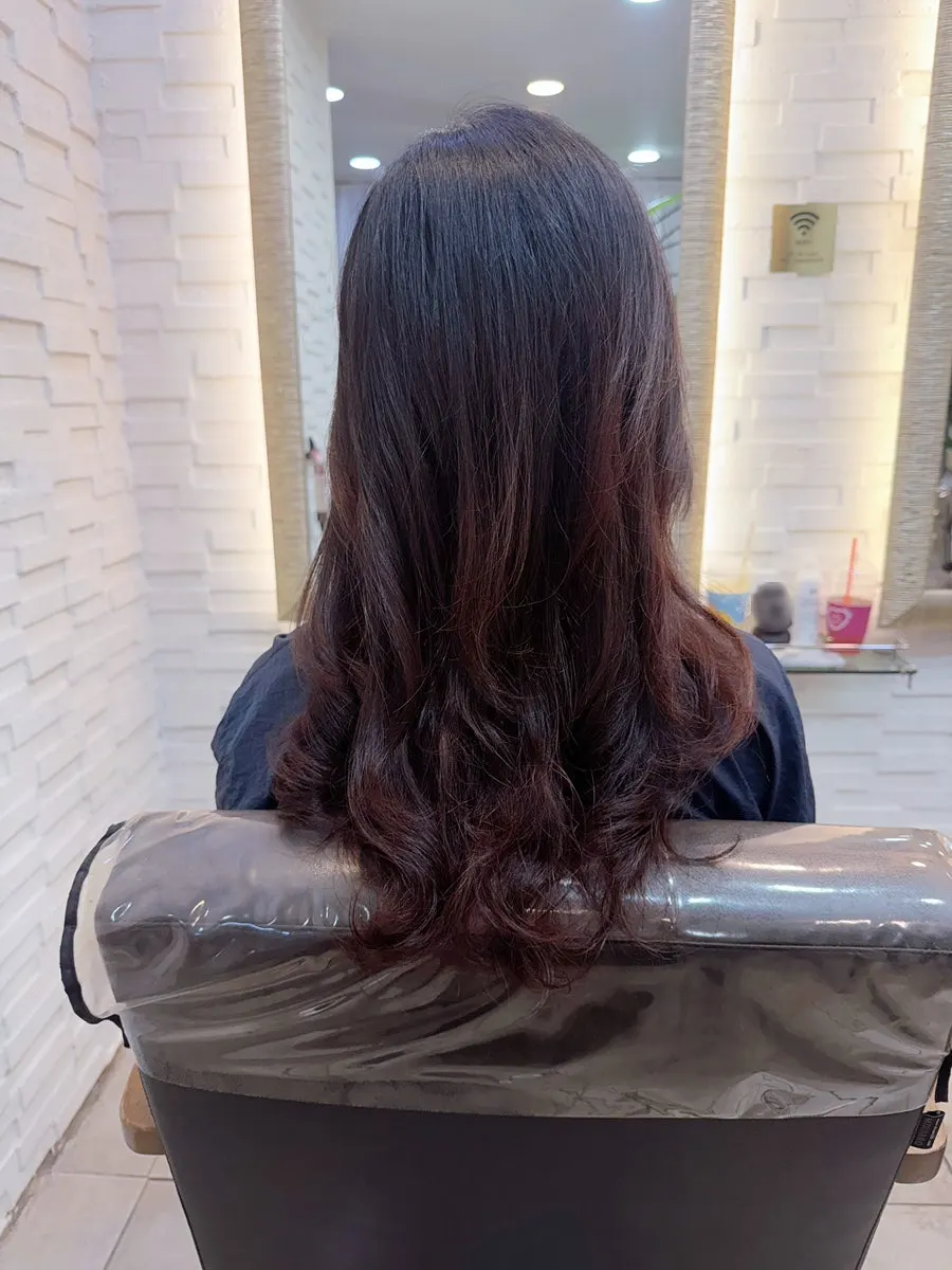 Checking the treatment results in front of the salon mirror