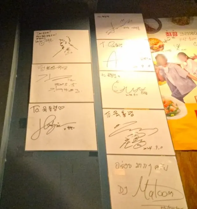 계단 벽에 붙은 방송 출연 사인들