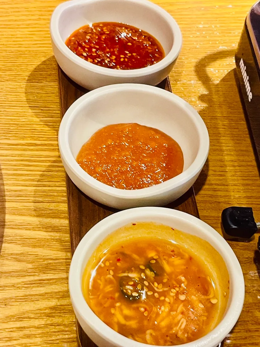 Three sauces: ssamjang, shrimp sauce, and mala sauce