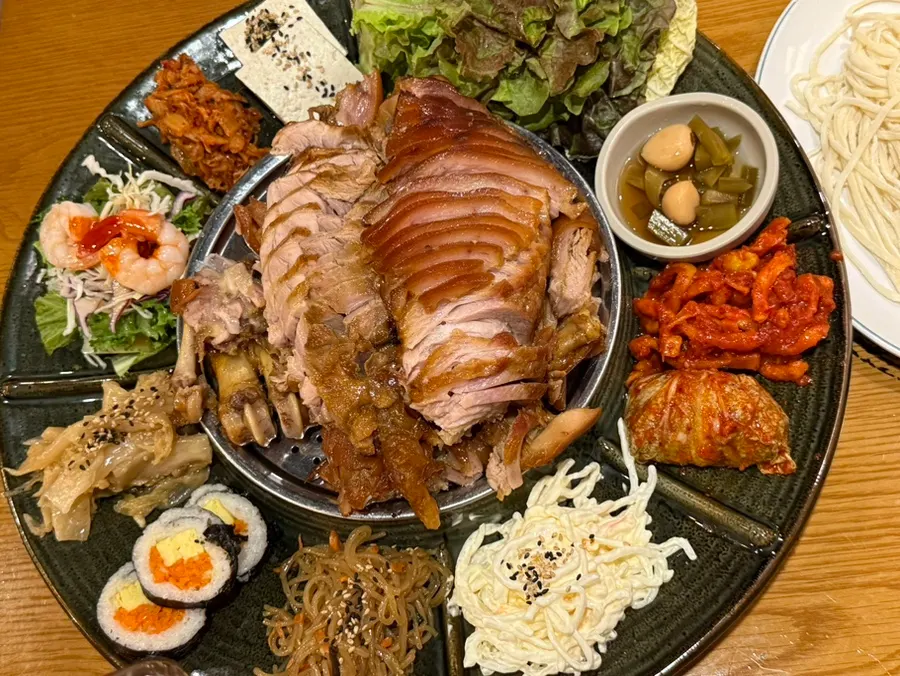 Table filled with jokbal and side dishes