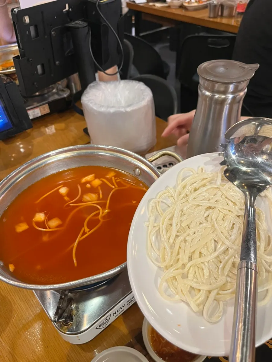 Kimchi kalguksu bubbling as it boils