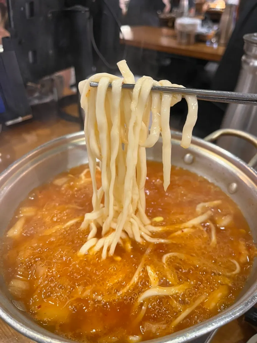Kimchi kalguksu served in a bowl