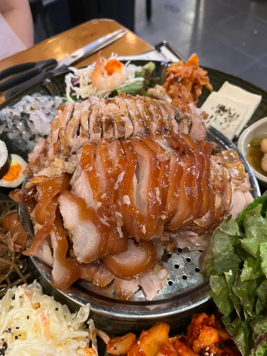 Emperor's jokbal set surrounded by side dishes