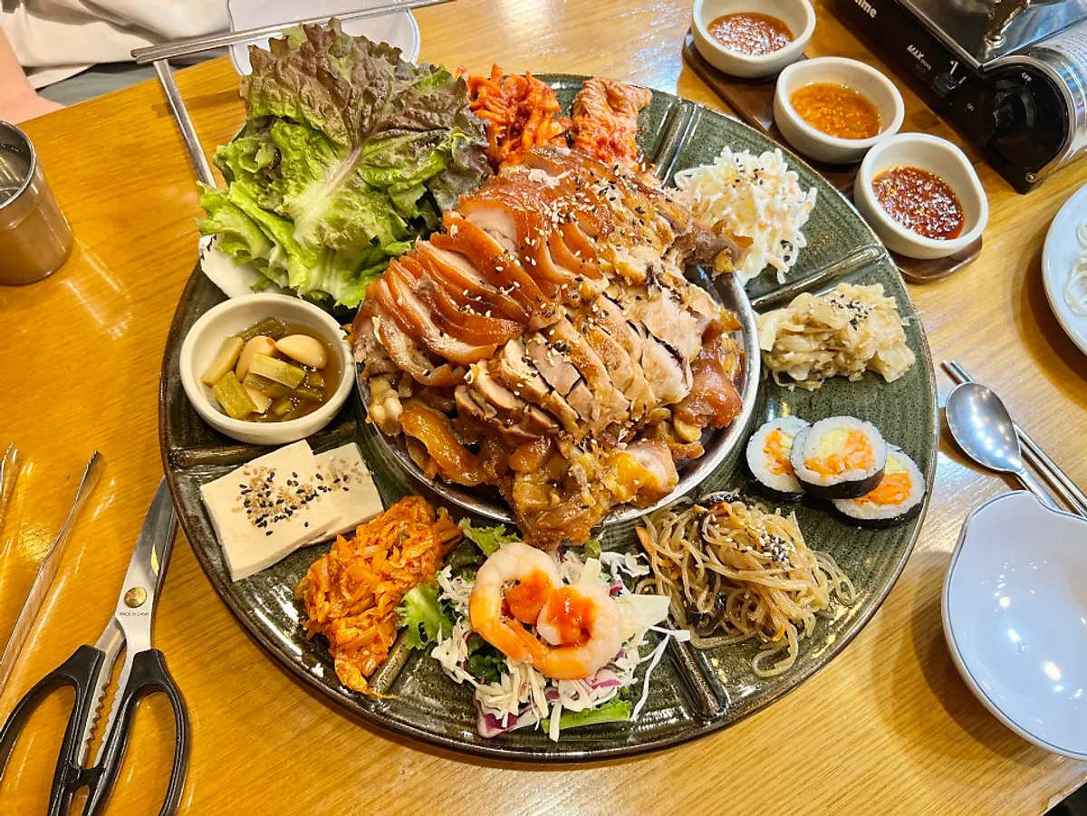 Emperor Jokbal served on a large platter with side dishes