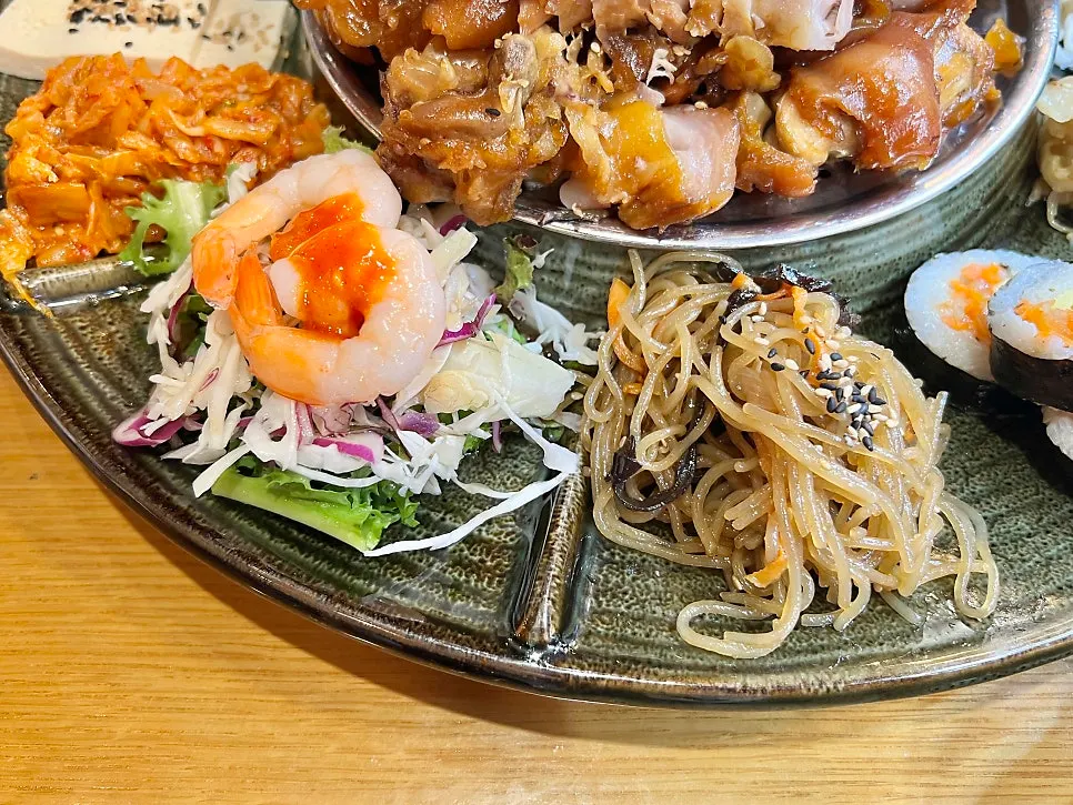 Vegetable salad topped with shrimp, and japchae
