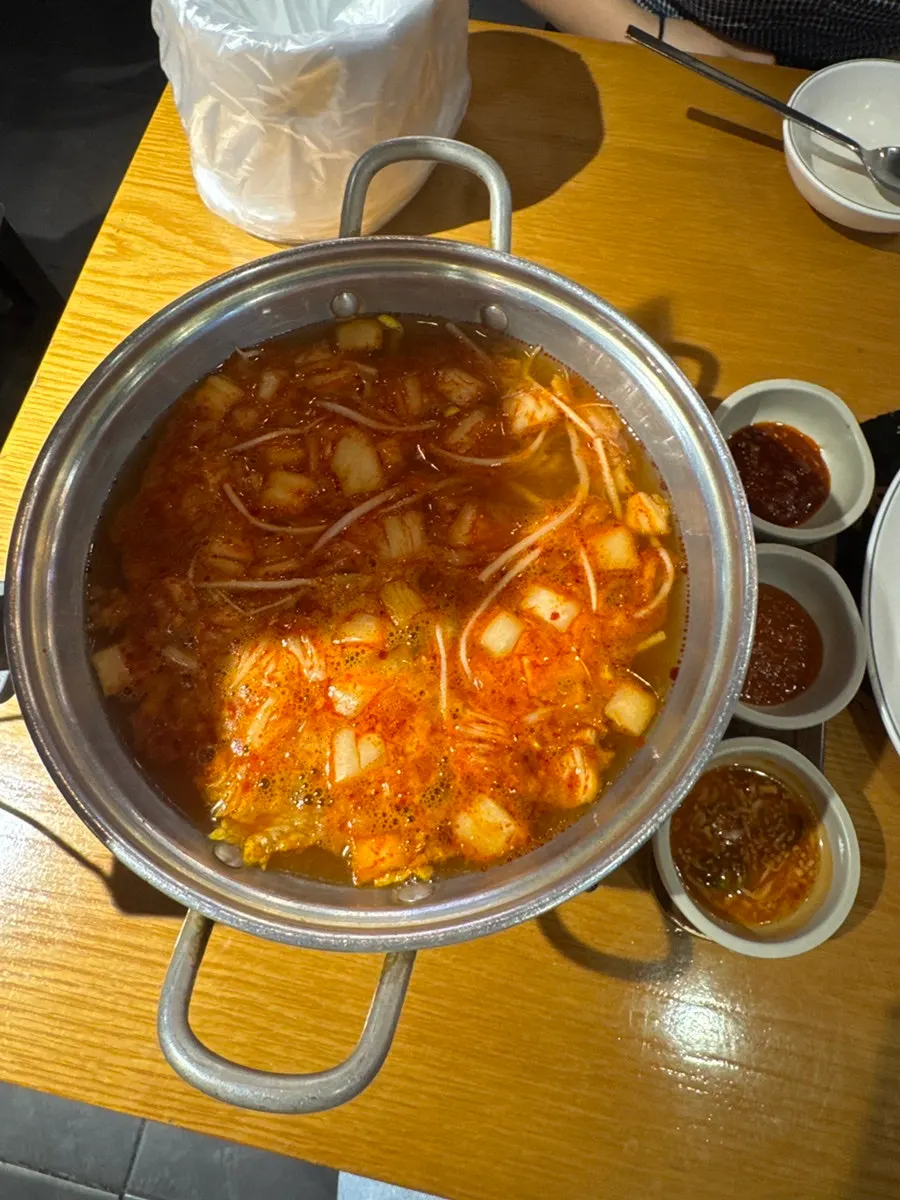 Kimchi kalguksu broth in a pot