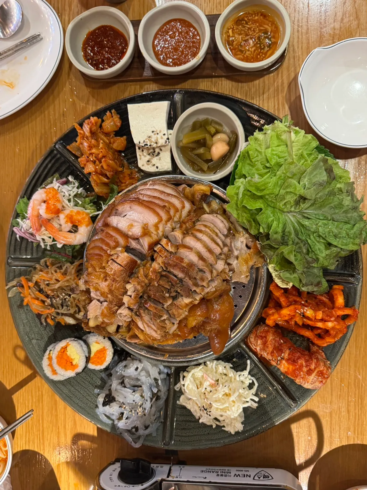 Emperor Jokbal platter surrounded by side dishes