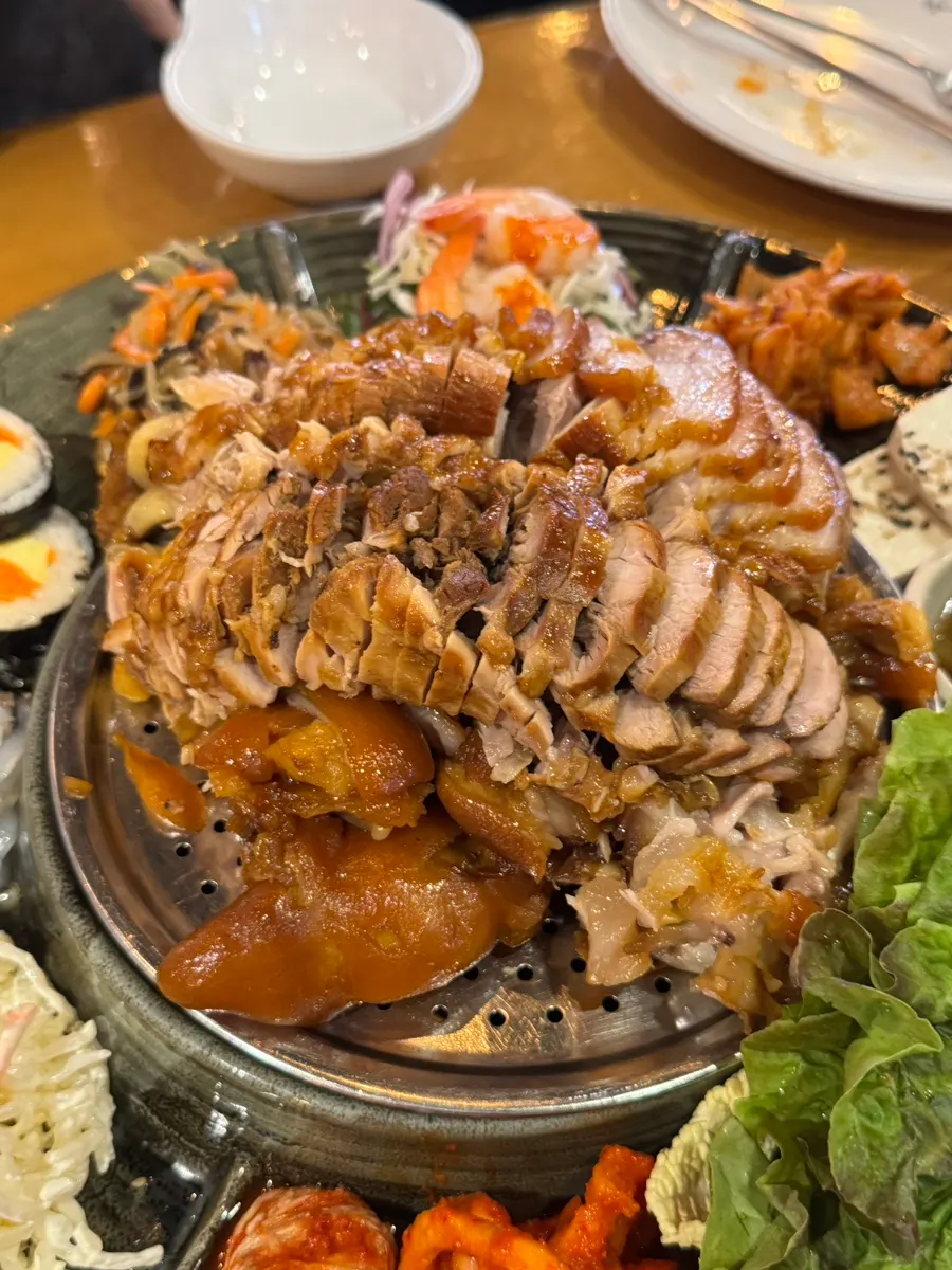 Emperor Jokbal with assorted side dishes