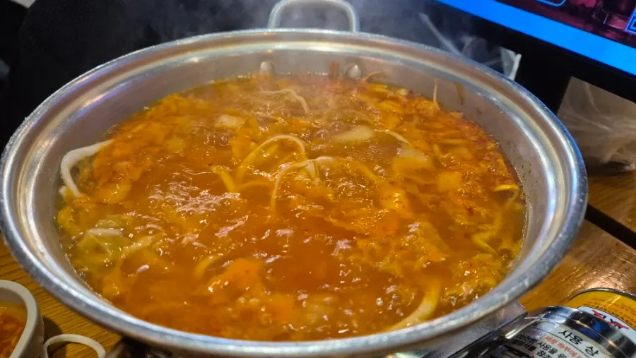 A bowl of the complimentary kimchi kalguksu noodle soup