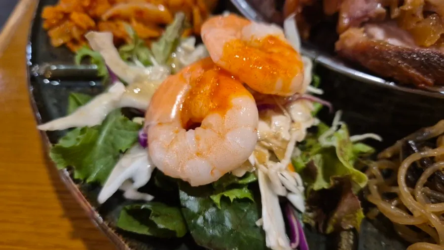 Side dishes including japchae, gimbap, shrimp, and jelly