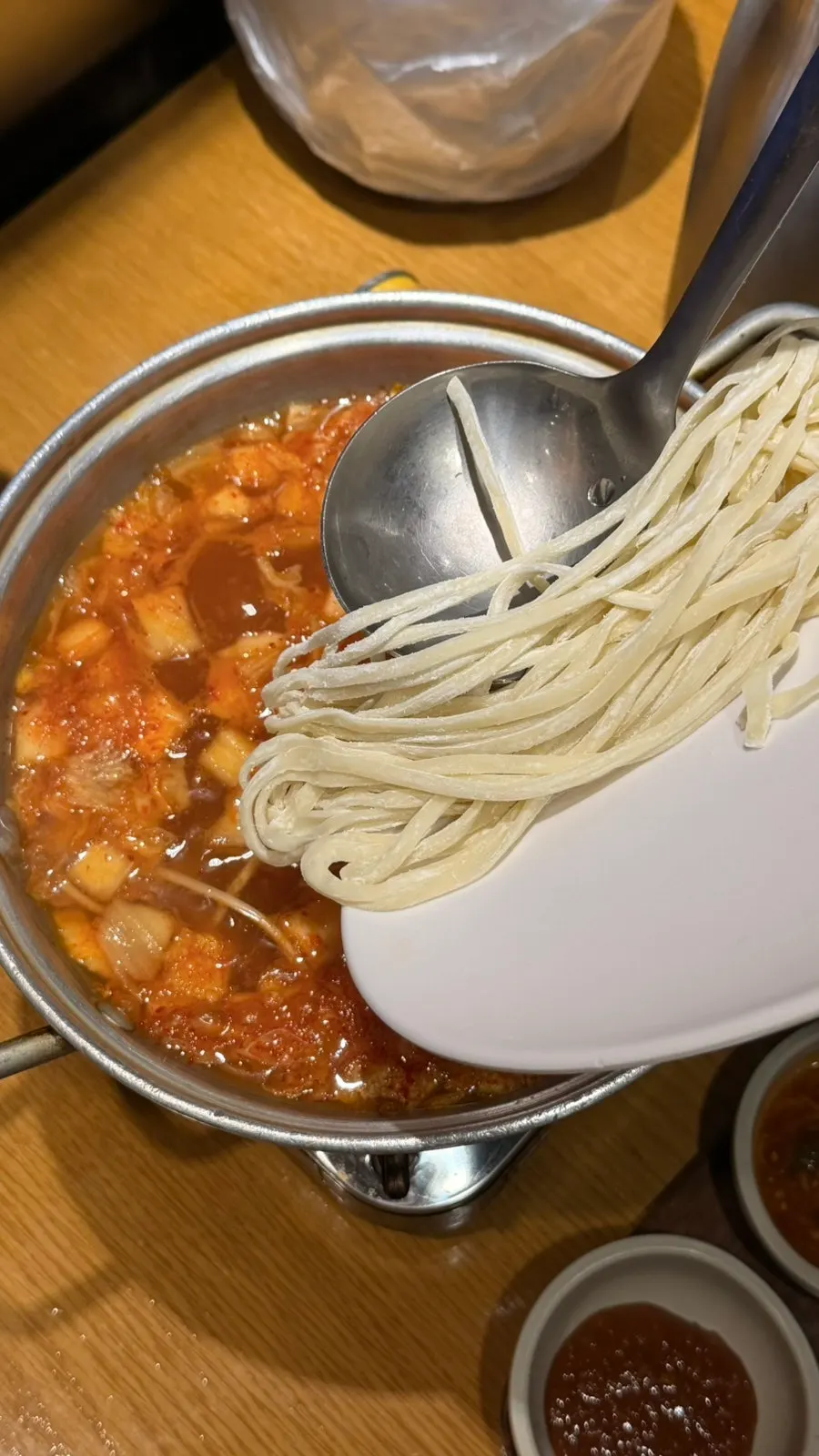 Spicy kimchi kalguksu served as an appetizer
