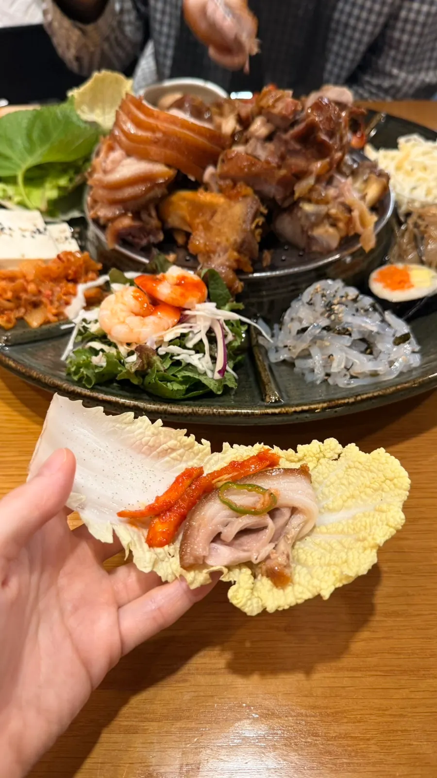 Radish bossam kimchi with a piece of jokbal