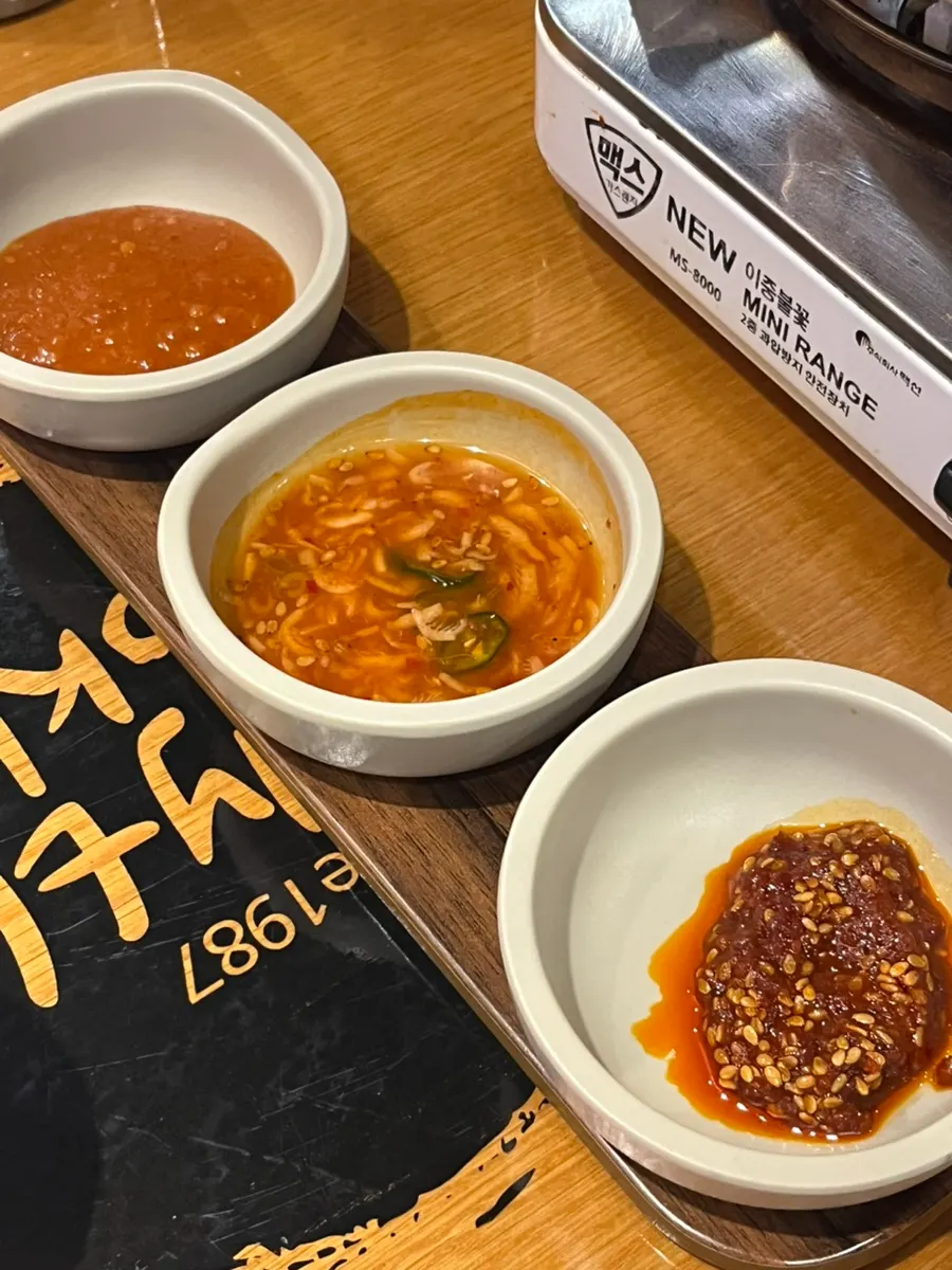 Three sauces: ssamjang, salted shrimp sauce, and mala sauce