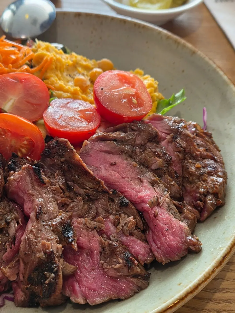 A piece of steak lifted with a fork