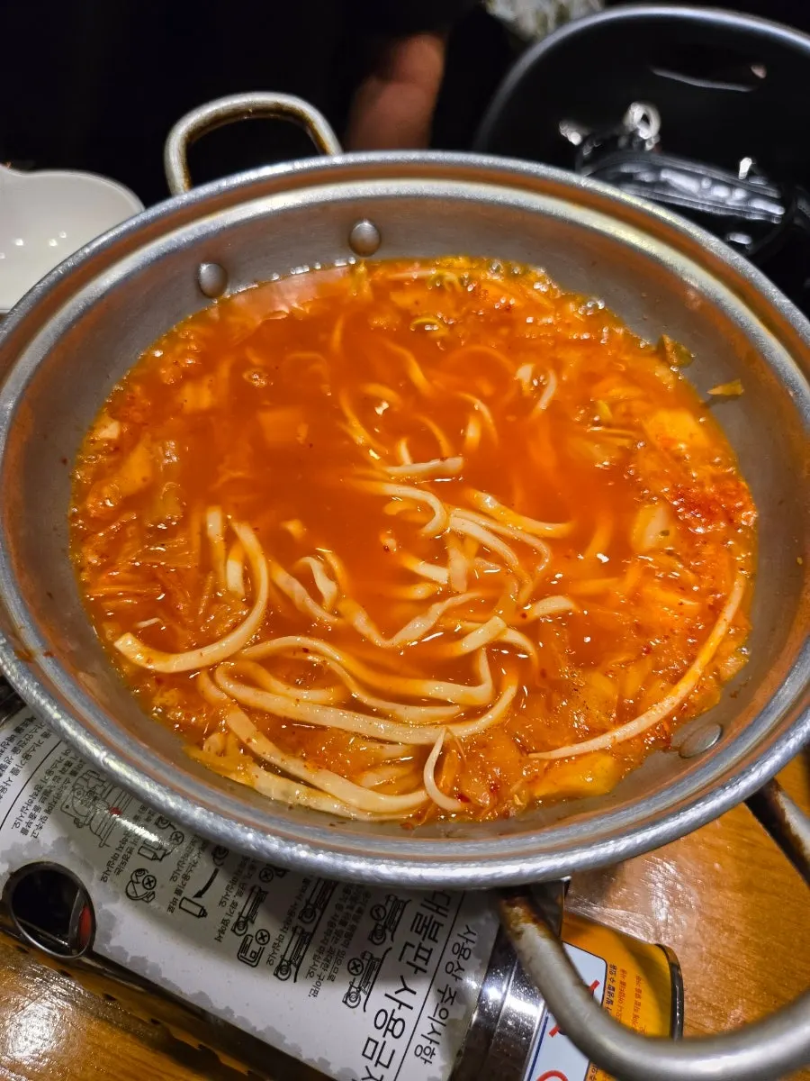 Spicy kimchi kalguksu broth and noodles