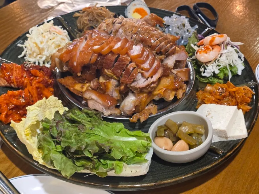 Gimbap and japchae served alongside the jokbal set