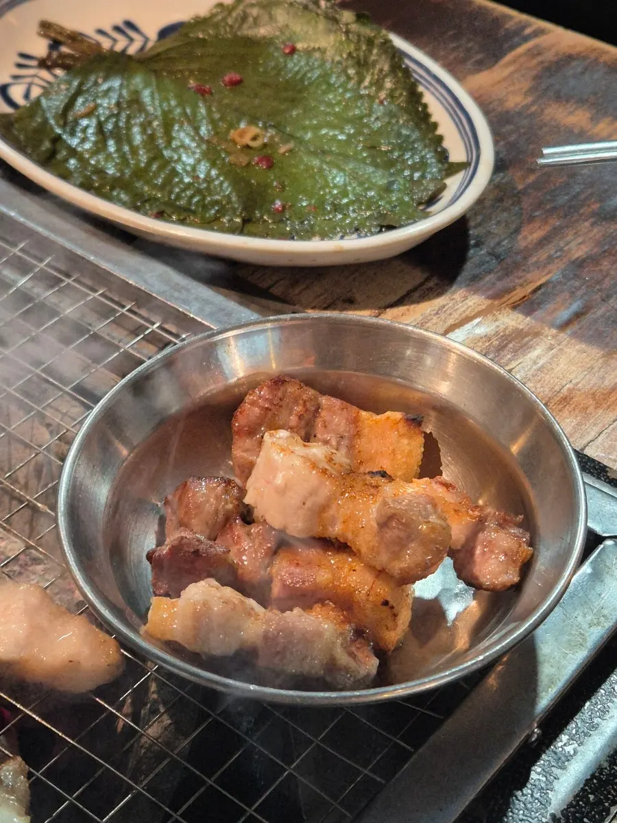 Staff grilling omija-aged pork belly