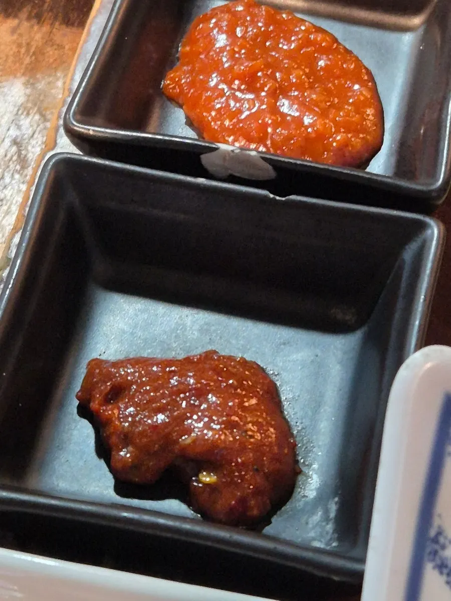 A piece of pork belly with wasabi