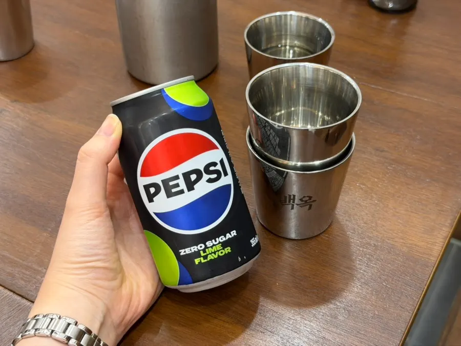A table set with bottled water and kkakdugi