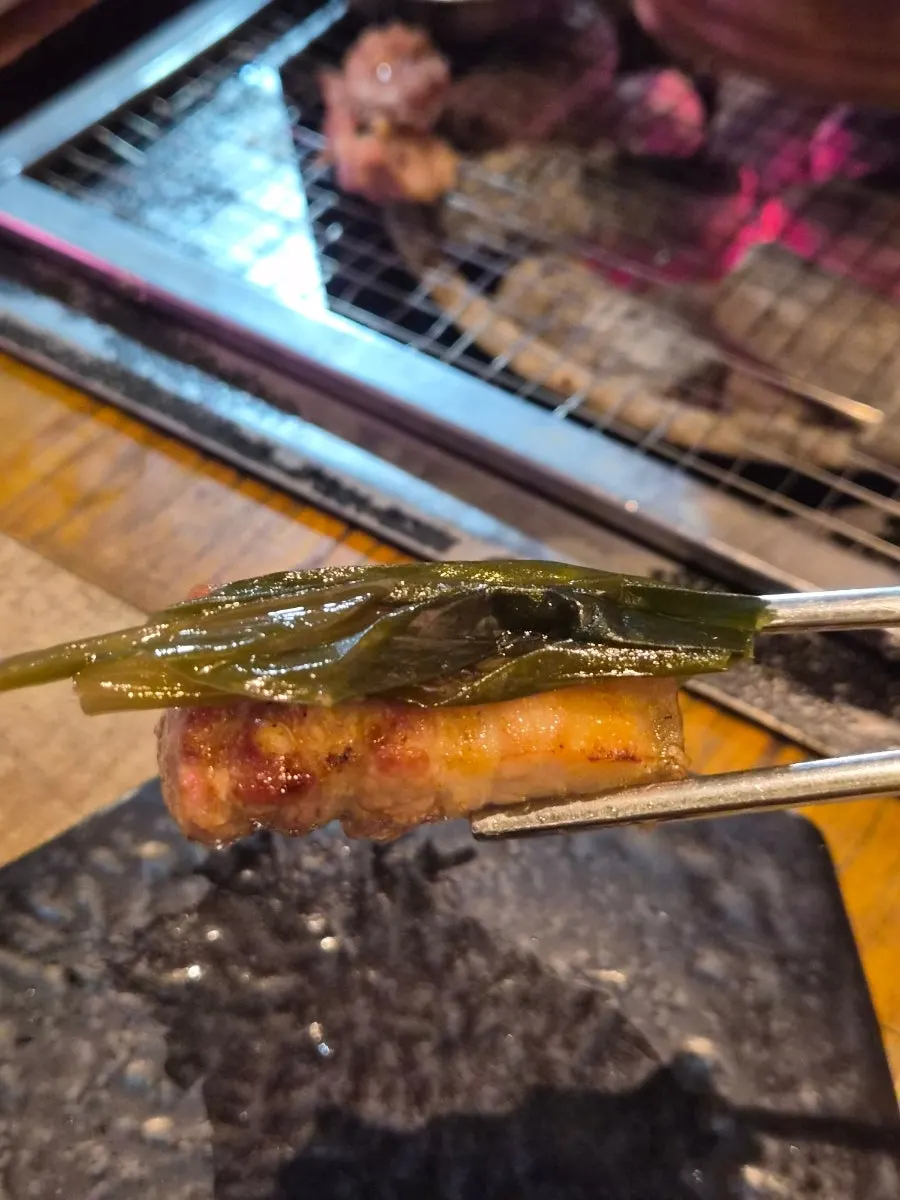 Black pork yukgyeopsal wrapped in a perilla leaf