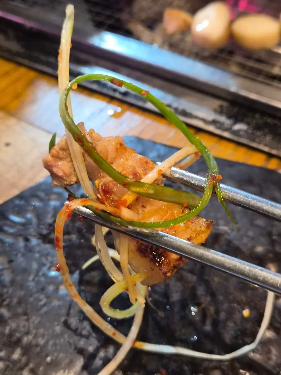 A piece of meat topped with wasabi