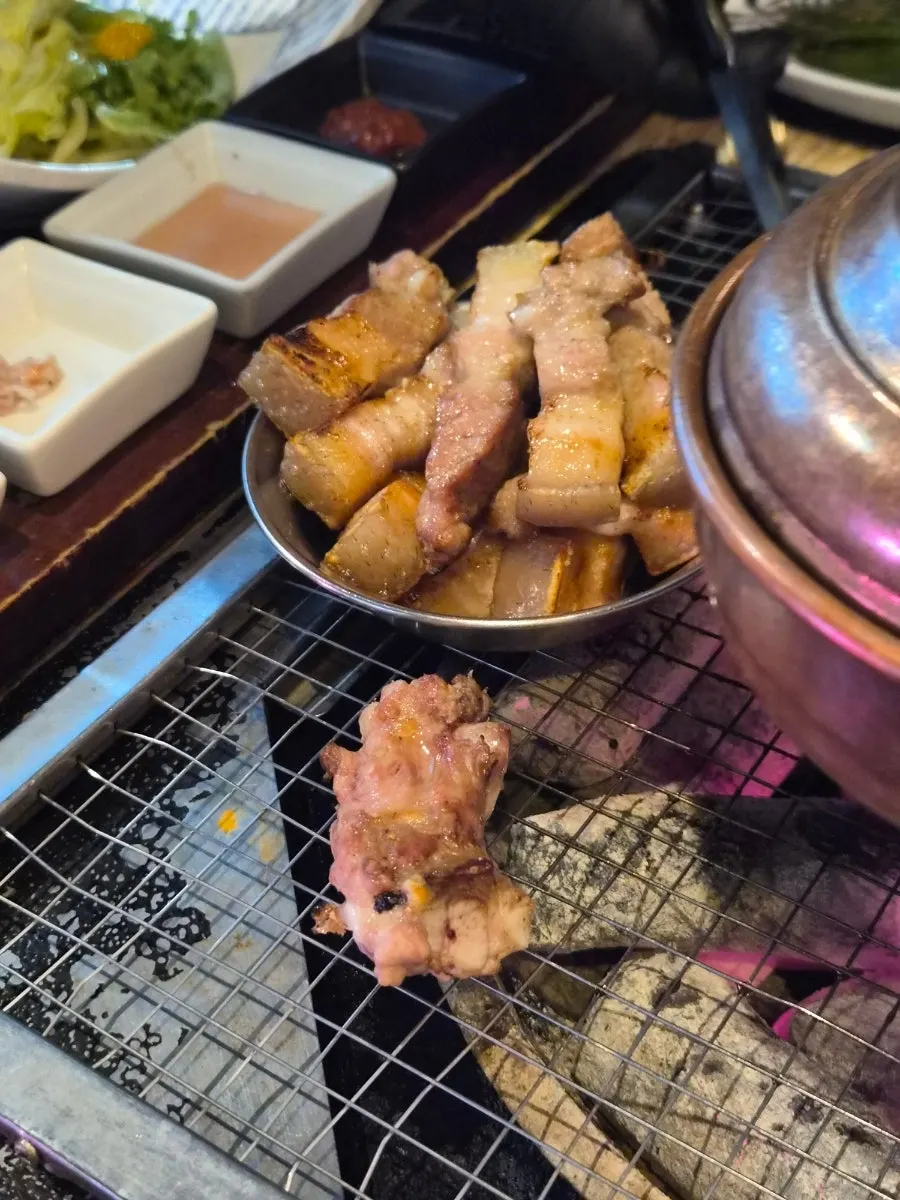 A bowl piled high with grilled meat