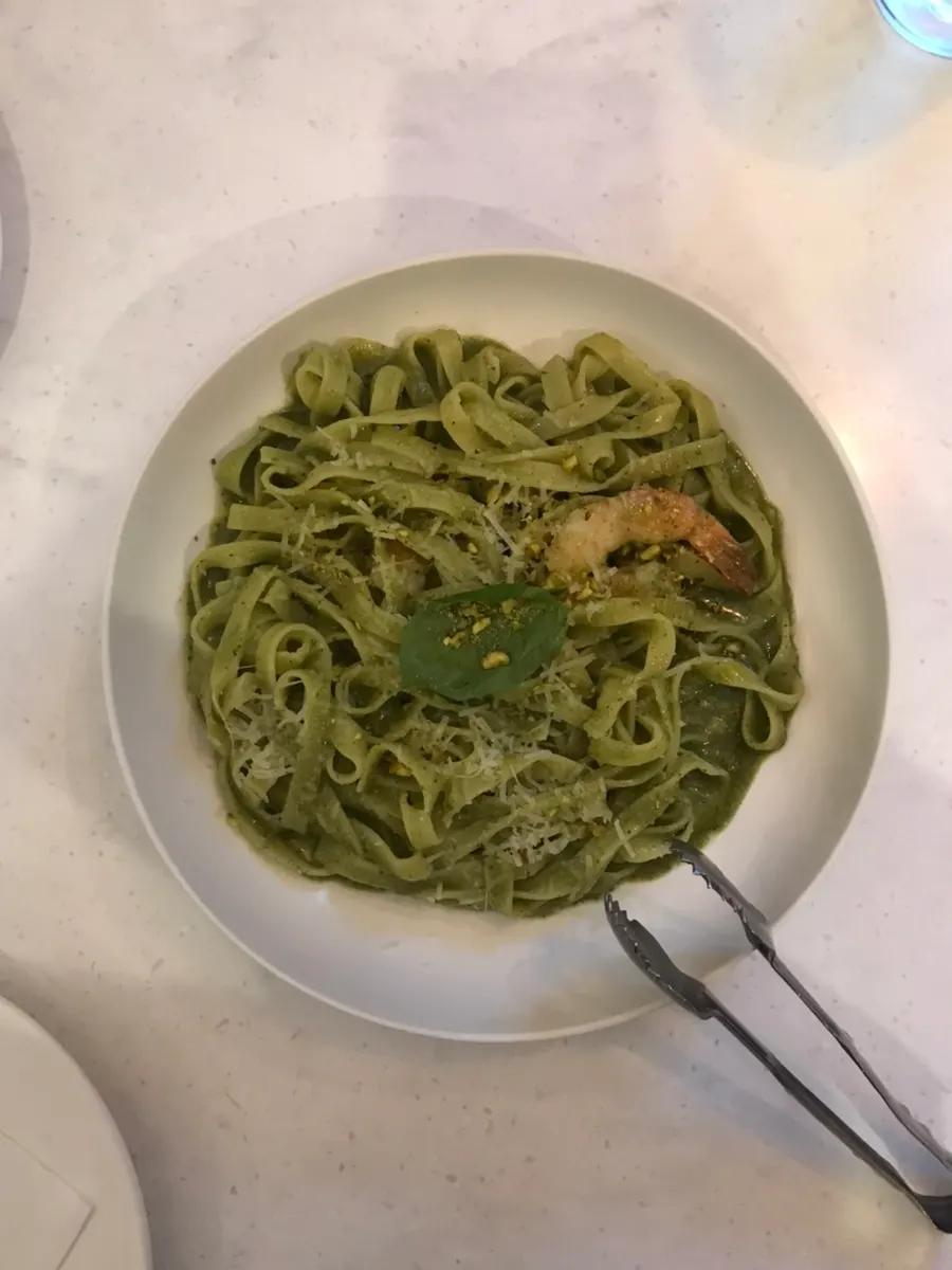 Combination pizza and basil pesto pasta served together