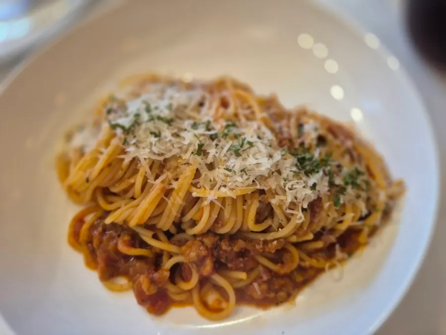 Pasta noodles tossed in ragu sauce