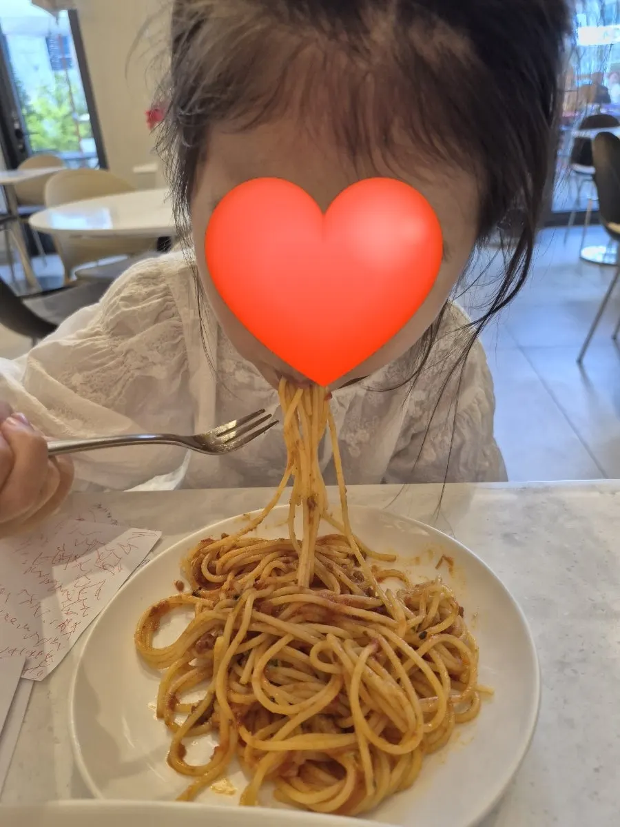 Table of ragu pasta shared with a child