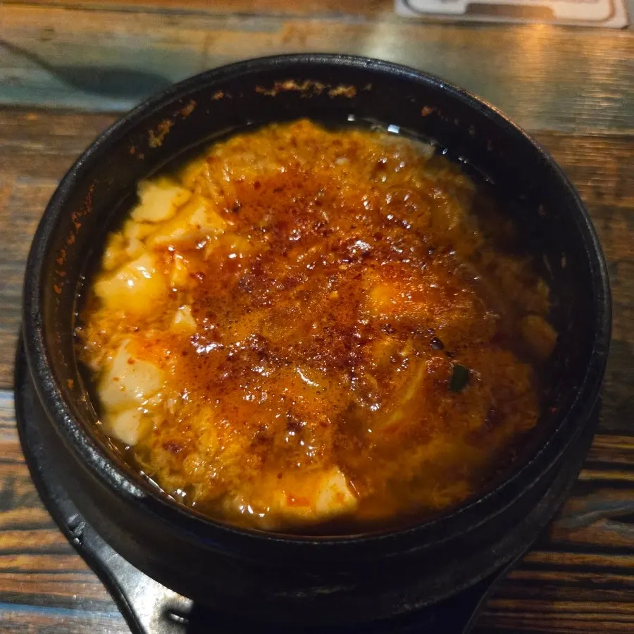 Complimentary gorgonzola pizza and sundubu-jjigae