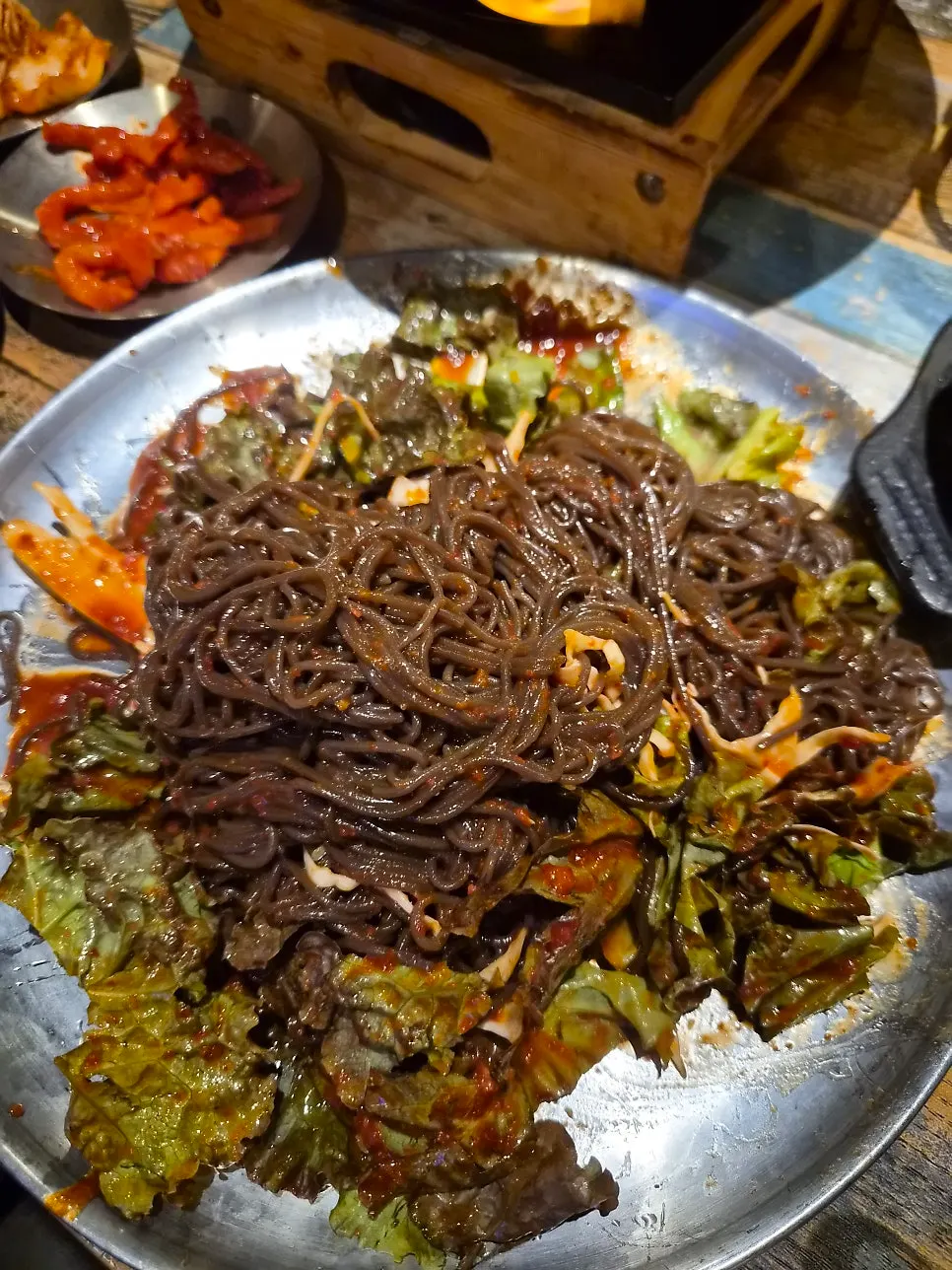 Bossam topped with makguksu noodles