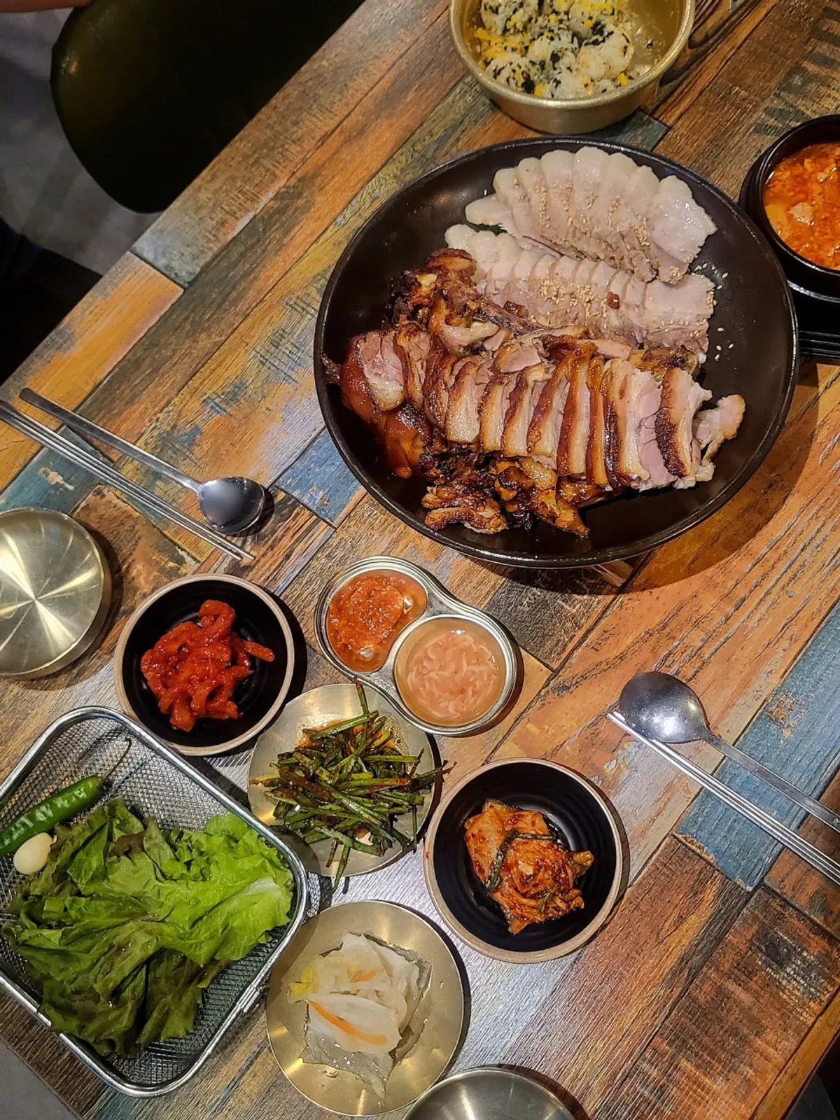 Wood-fired jokbal and bossam table setting at Iseon Hwaduk Jokbal Bossam Myeongil Branch