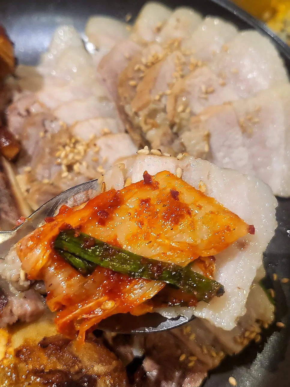 Piece of bossam dipped in salted shrimp