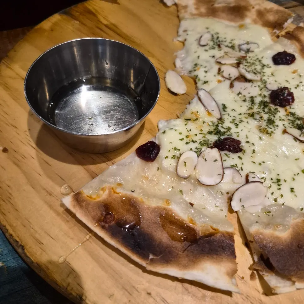A slice of hwaduk pizza with stretchy cheese