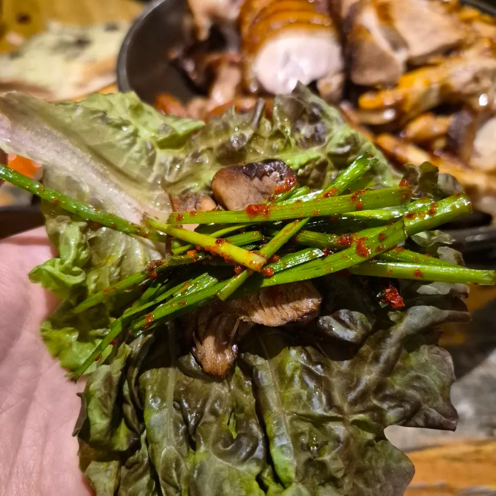 Jokbal topped with chive salad