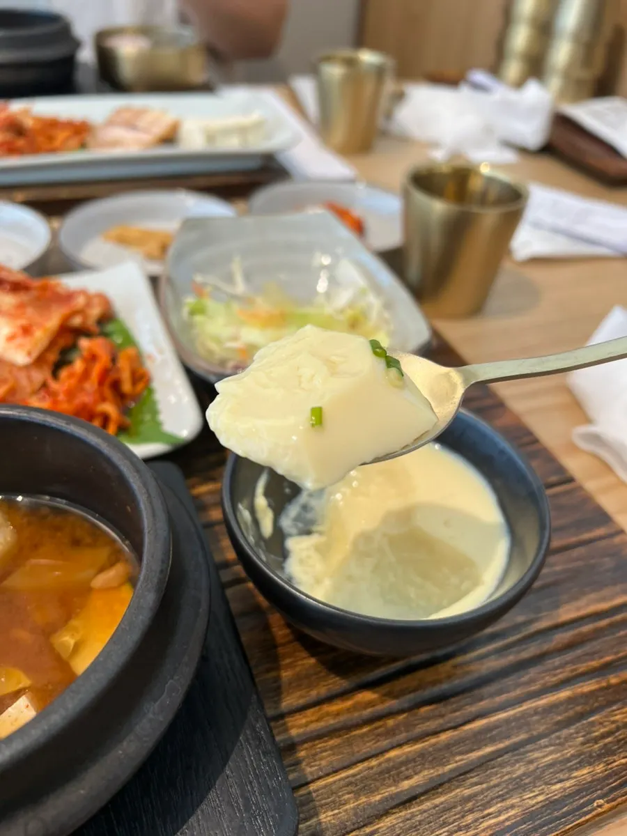 Warm soft tofu topped with bossam and kimchi