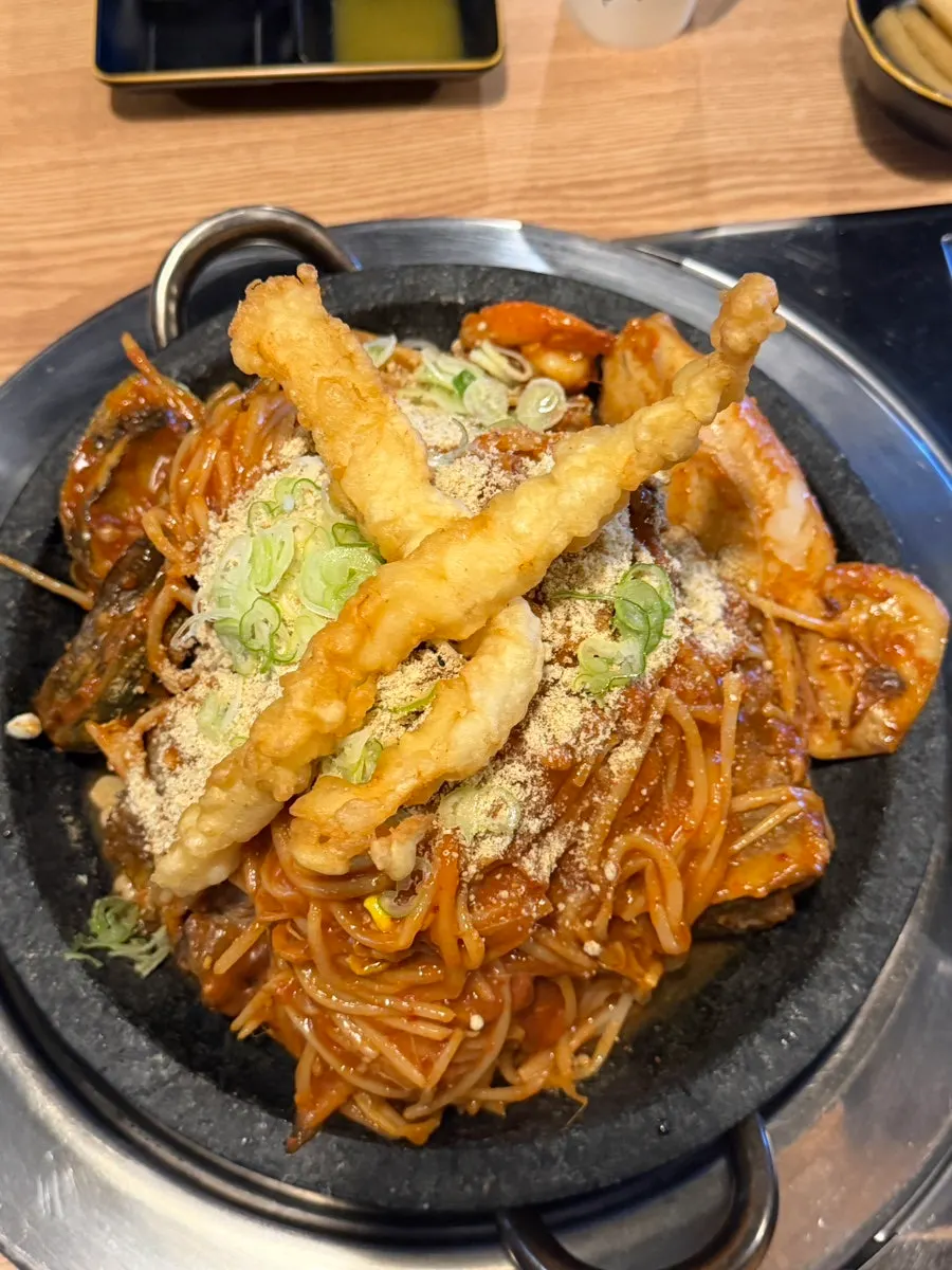 Hot stone seafood pork bone jjim topped with fried squid