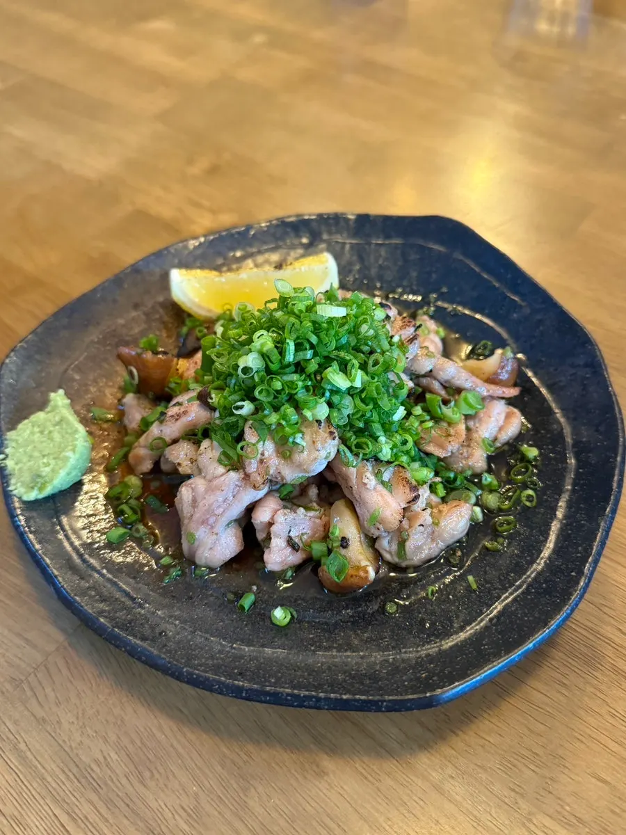 A piece of grilled cuttlefish being picked up