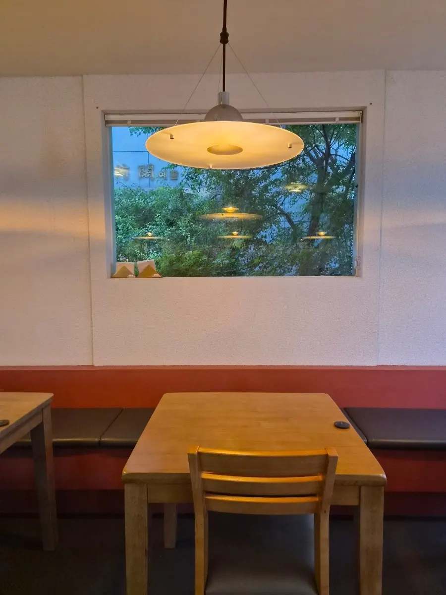 Interior view with a tree visible through a small window