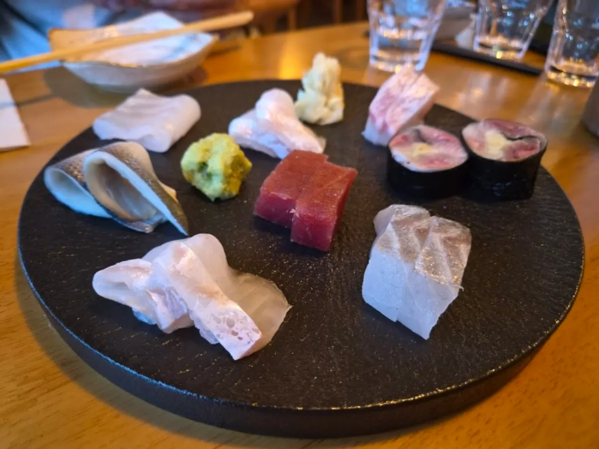 Aged sashimi platter for two on a black plate