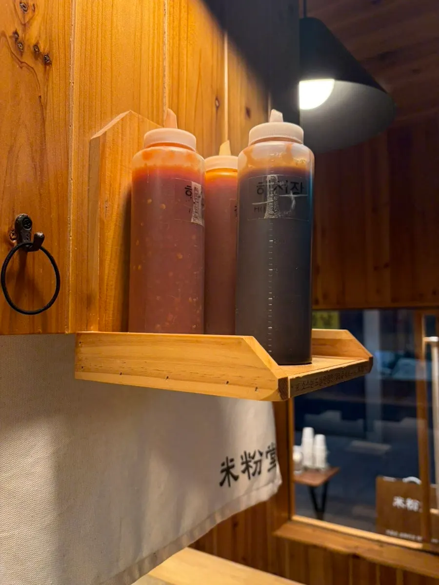 Pho sauces set on an overhead shelf