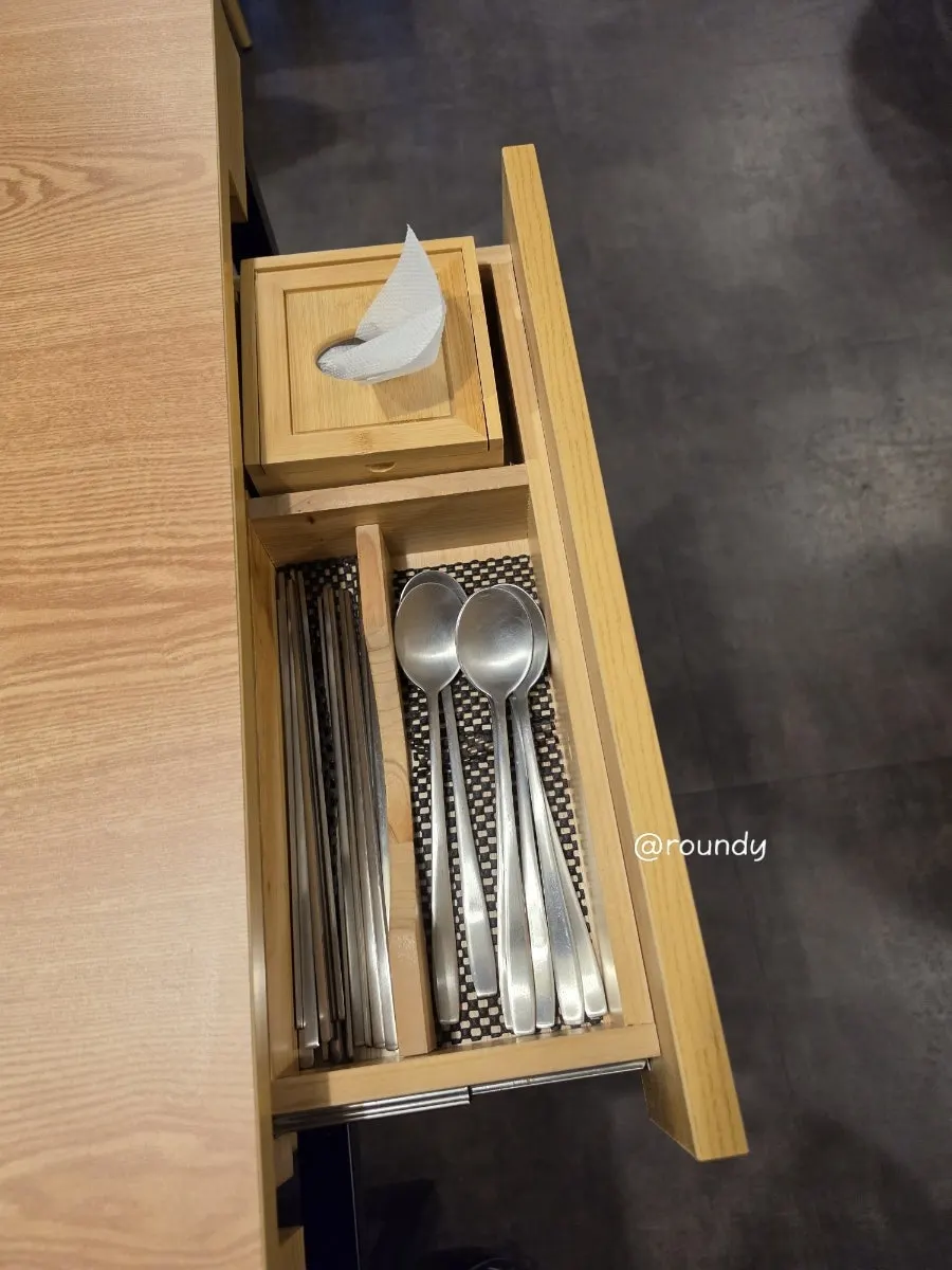 Table drawer holding utensils and tissues