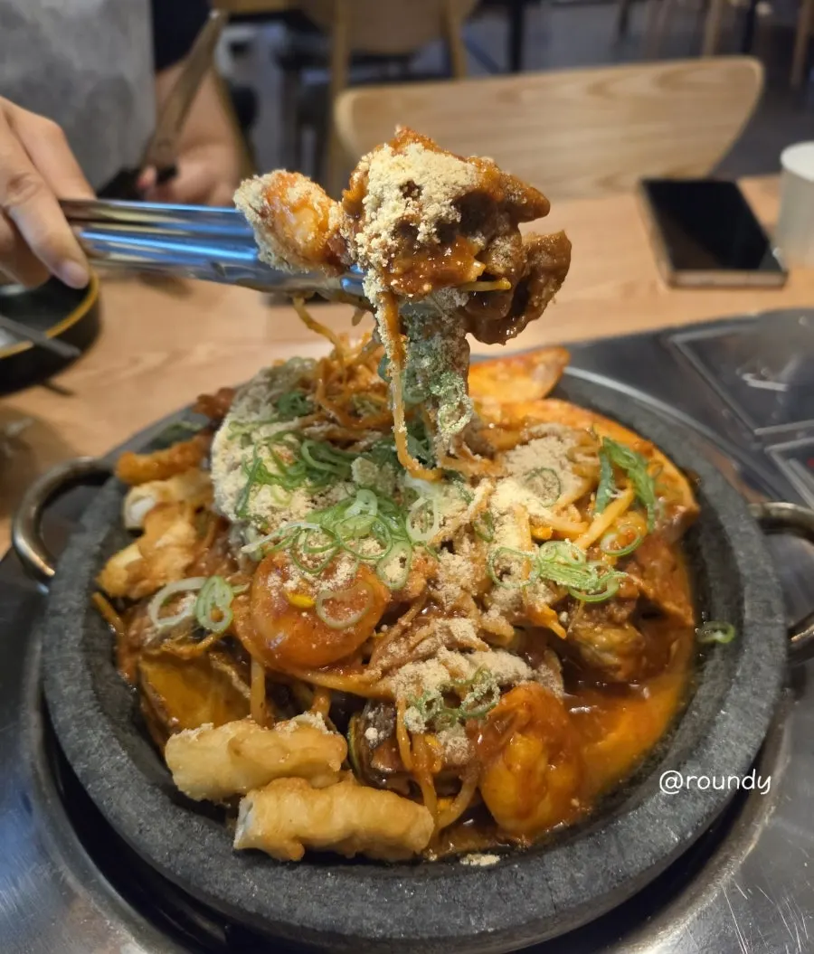 A stone plate full of the 2-person seafood pork bone jjim
