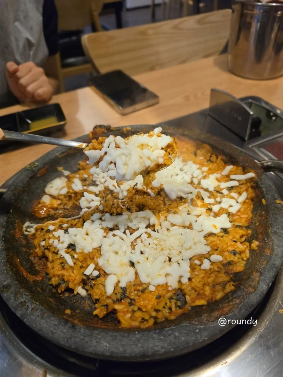 Fried rice being made with kimchi in the leftover sauce