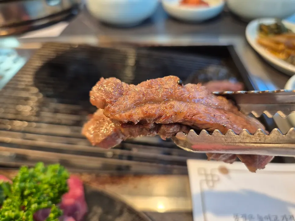 A piece of hanwoo striploin picked up with chopsticks