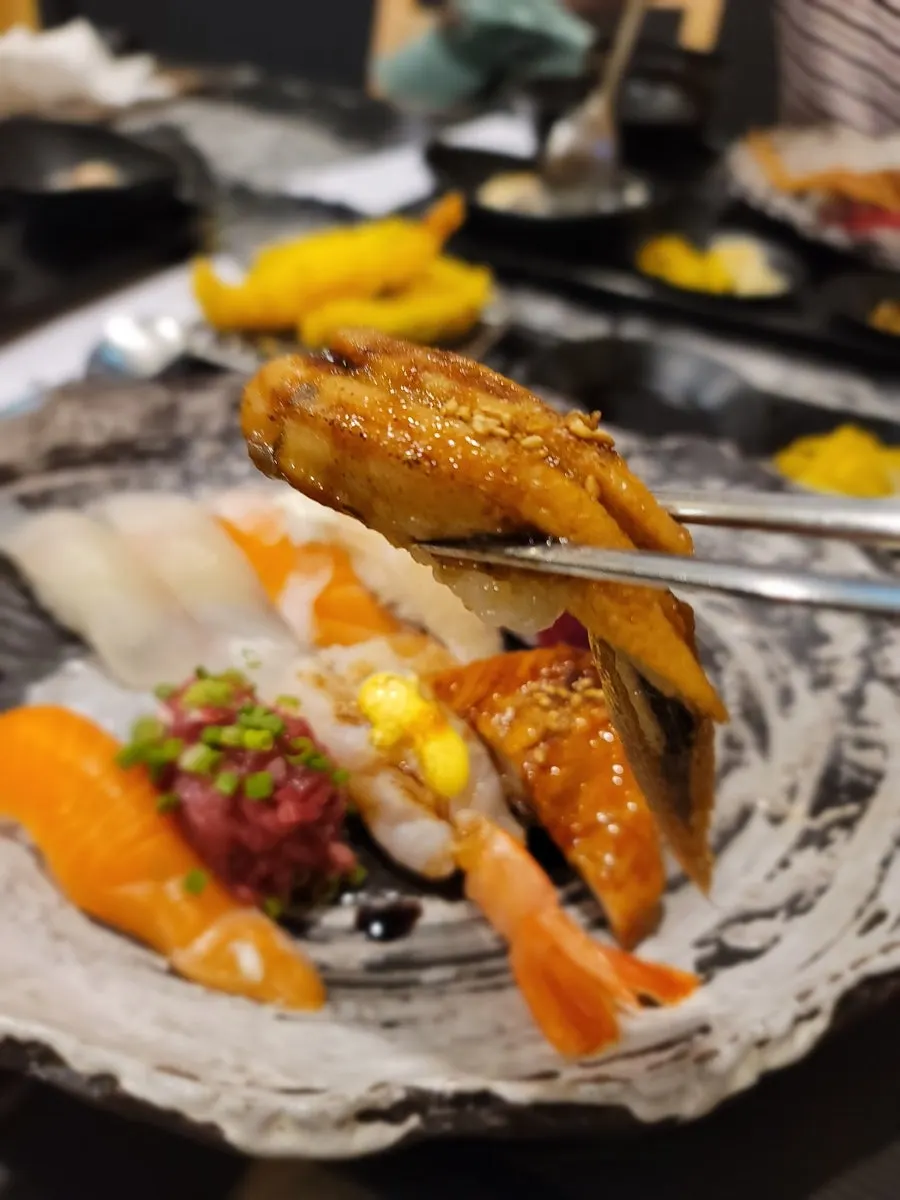 Sushi with small rice portion and thick fish slices