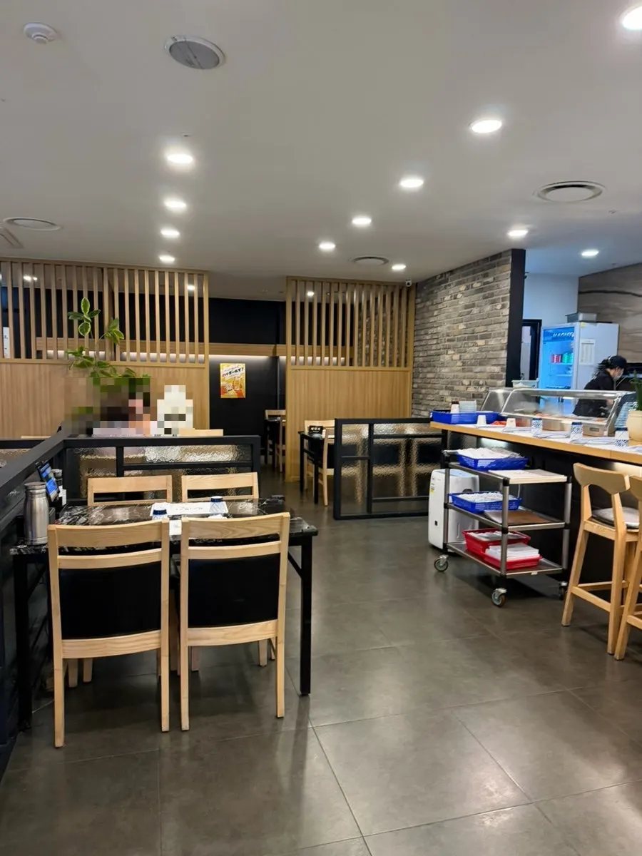 Interior of Moshi Moshi Sushi arranged mostly with 4-person tables