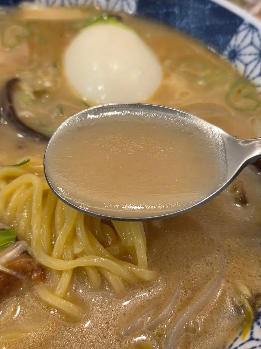 Overhead view of ramen topped with chashu and egg